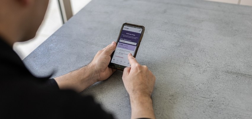 Man looking at his energy online account using a smart phone