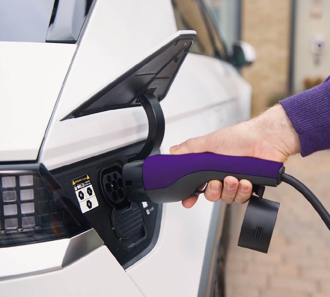 A hand inserting charger into car